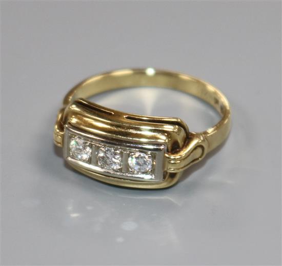 A 14ct gold and three stone channel set diamond ring, size O.